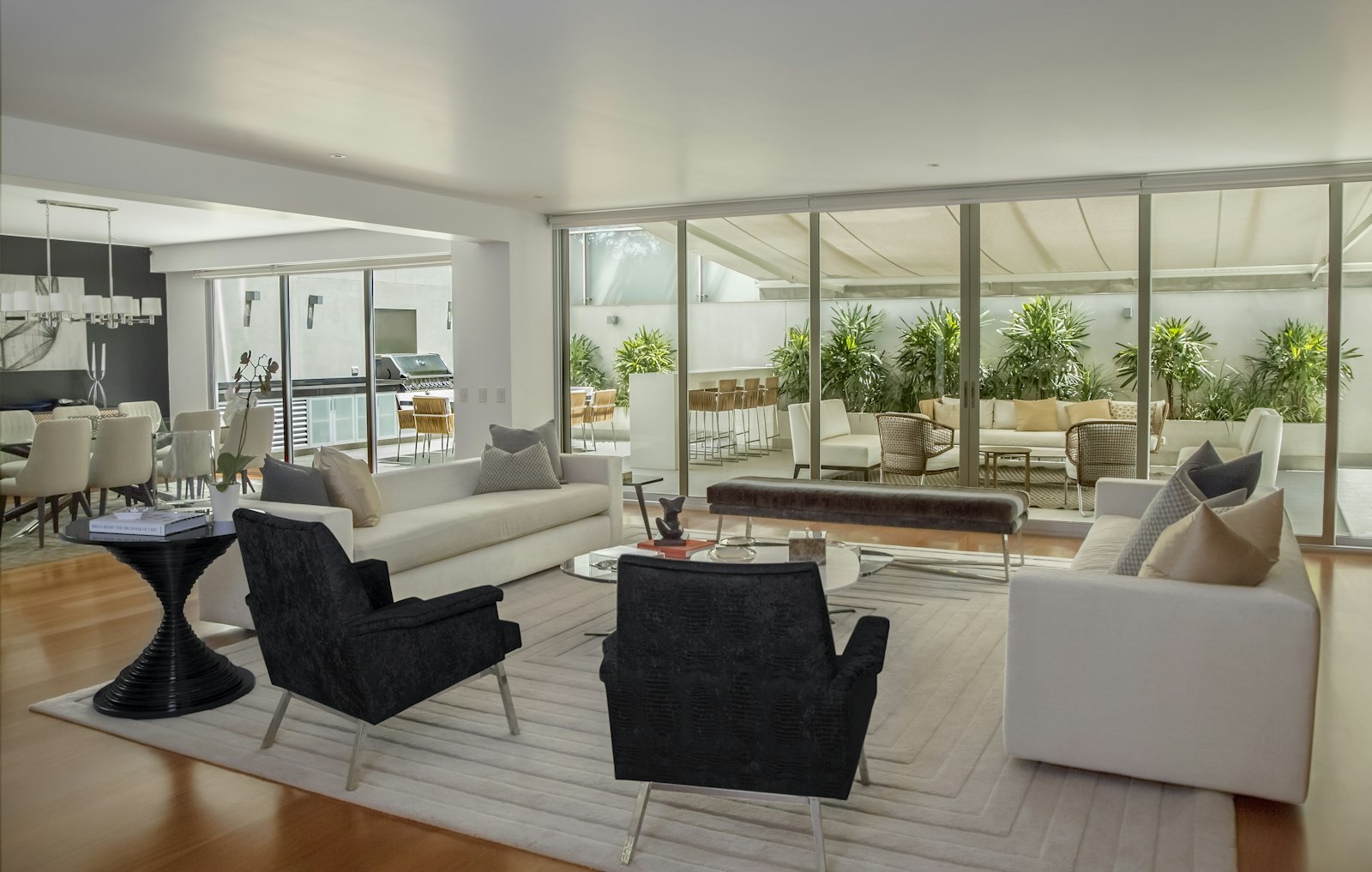 Open-plan living room with floor-to-ceiling sliding glass doors to a terrace