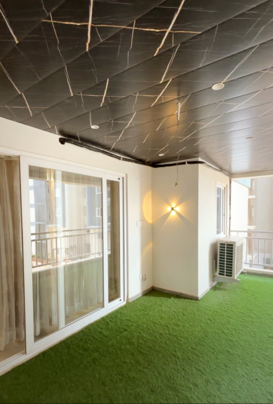 uPVC sliding door opening onto a balcony with a marble-look ceiling